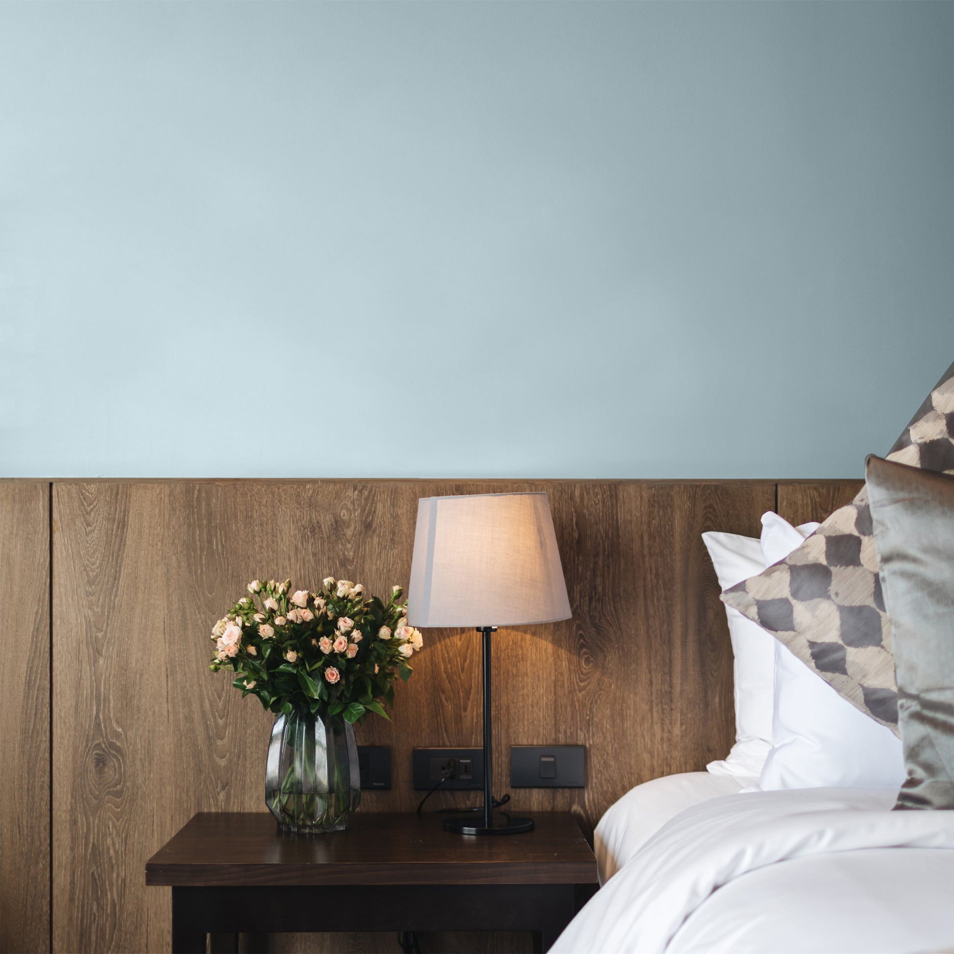 Pale blue-grey bedroom wall painted in Cage Dive